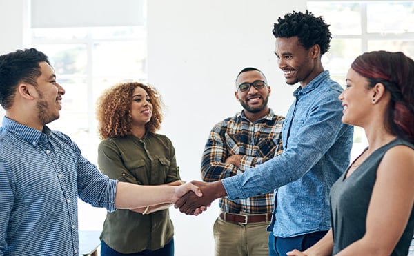 diverse-group-of-coworkers-greeting-each-other